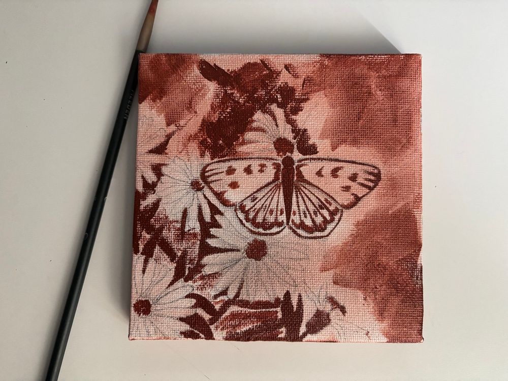 Sienna painting of a butterfly and daisies.