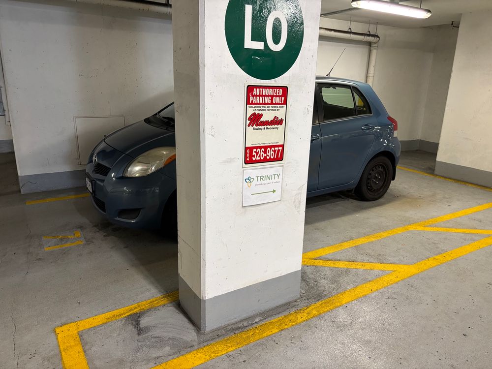 Underground parking space with concrete walls or pillar on three sides. 
