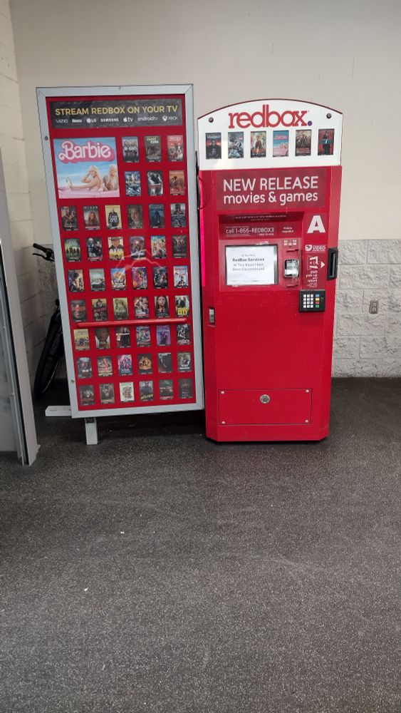 Redbox kiosk in store with discontinue sign on display 