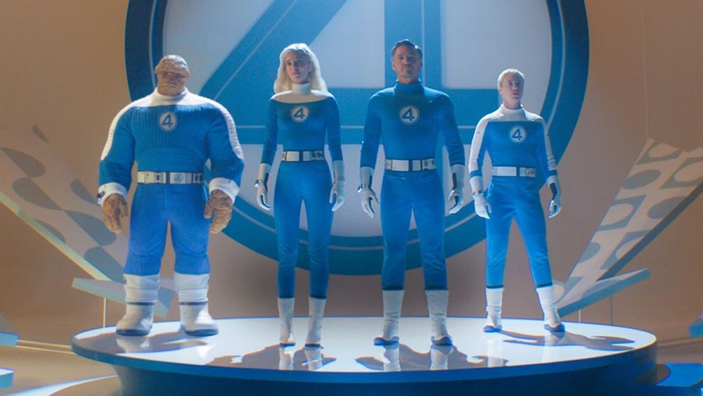The Fantastic Four stand heroically on a cute little platform with a big 4 behind them.