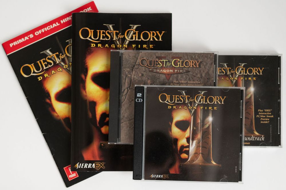 Contents of Quest for Glory 5 box: the game CD in a 2-CD case, the game manual, the short strategy guide available at some stores, and 2 versions of the CD soundtrack.