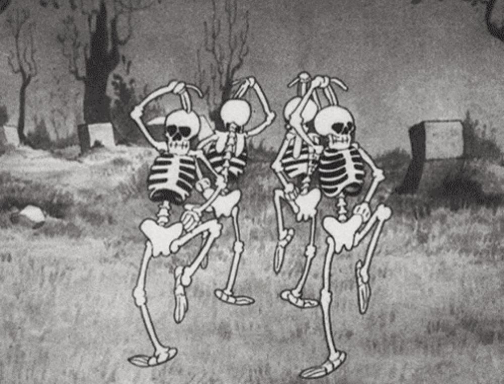 three skeletons are dancing in a cemetery