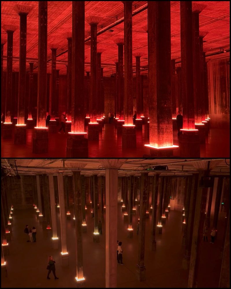 a photo of a vast subterranean tank full of thin columns, lit up mysteriously - red light