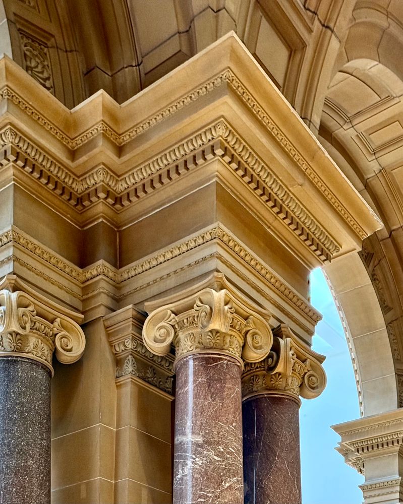 delicate volutes Ionic capitals inside a building