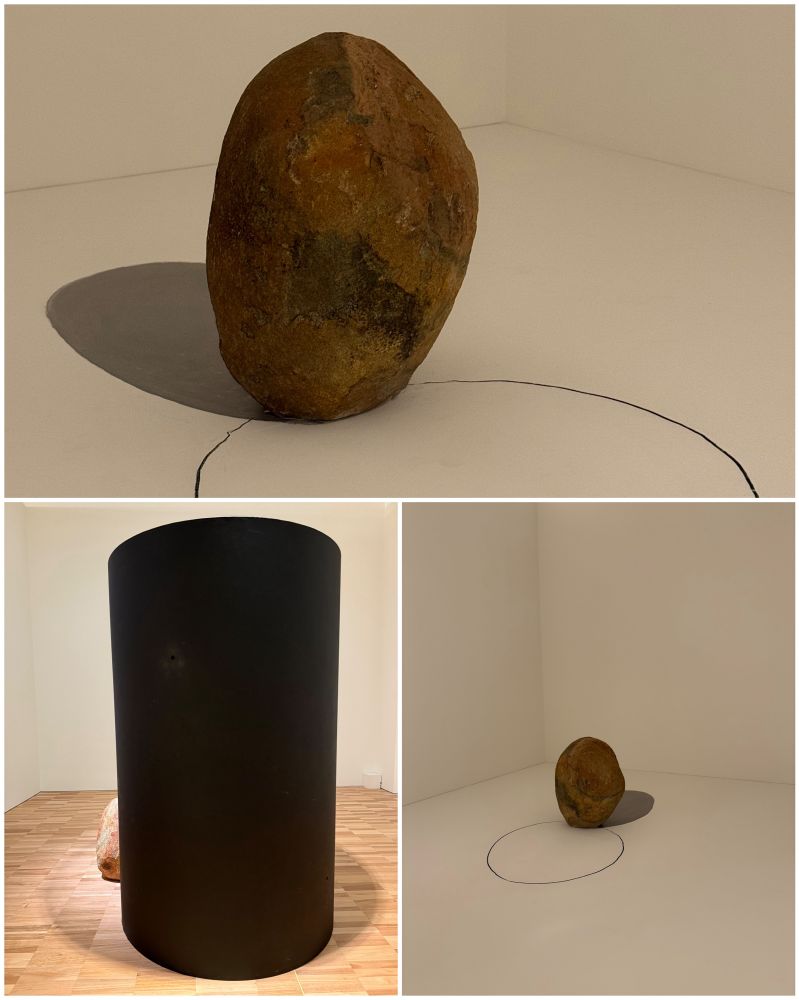 minimalist sculptures using rocks, one also with a rusty metal cylinder