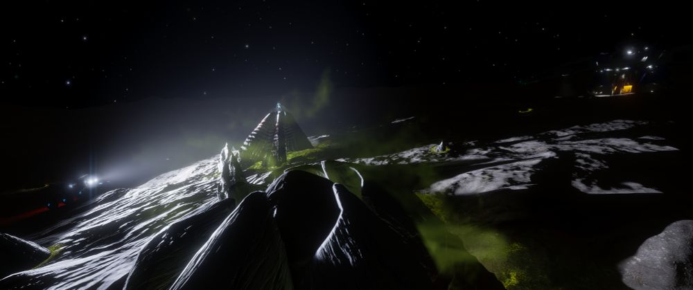 A wide shot taken at night of a Thargoid barnacle site in the Coalsack nebula. Showing a Surface Recon Vehicle on the left, with its headlights illuminating the barnacle in the middle as a commander stands on top. Over to the right, in the distance, are the lights of a Mandalay spacecraft.