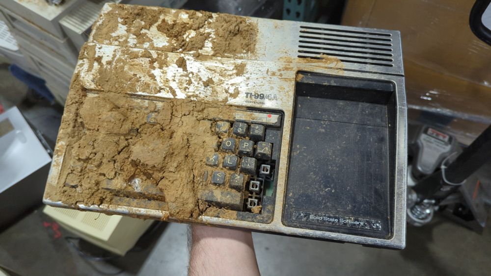A TI 99-4A covered in mud