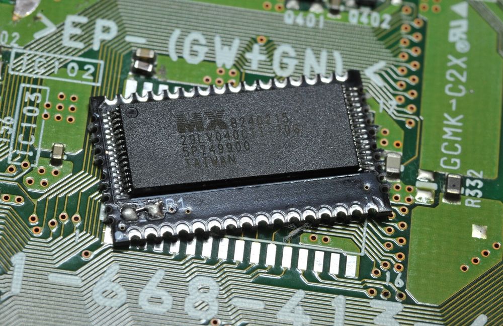 A carrier board for a new PS1 BIOS that I designed, with a parallel NOR flash chip soldered to it.