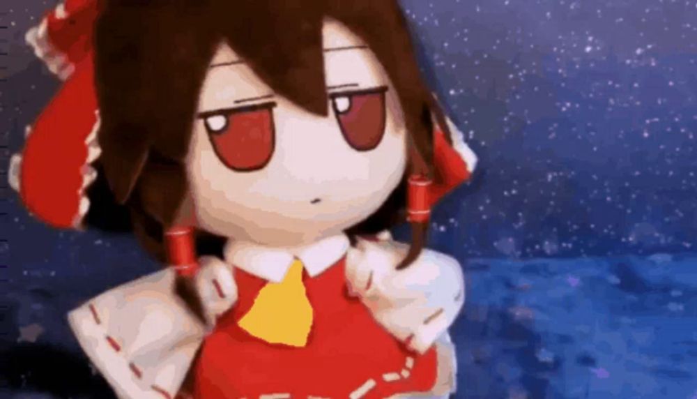 a stuffed doll in a red and white outfit with a yellow bow tie