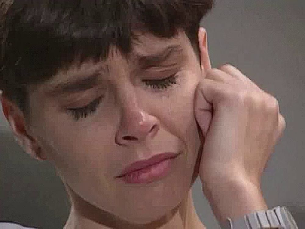 a close up of a woman 's face with tears running down her face .