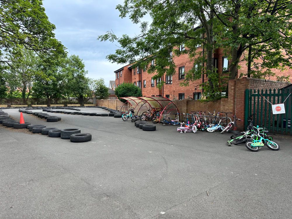 Lots of bikes and a track marked out in tyres