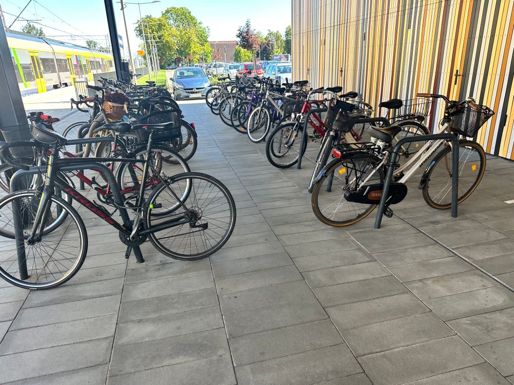 Lots of bikes parked up at a small town station in Poland