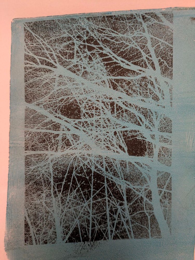 Tree branches with electricity pylon tower behind, but this time the image is in negative. Blue branches on black background 