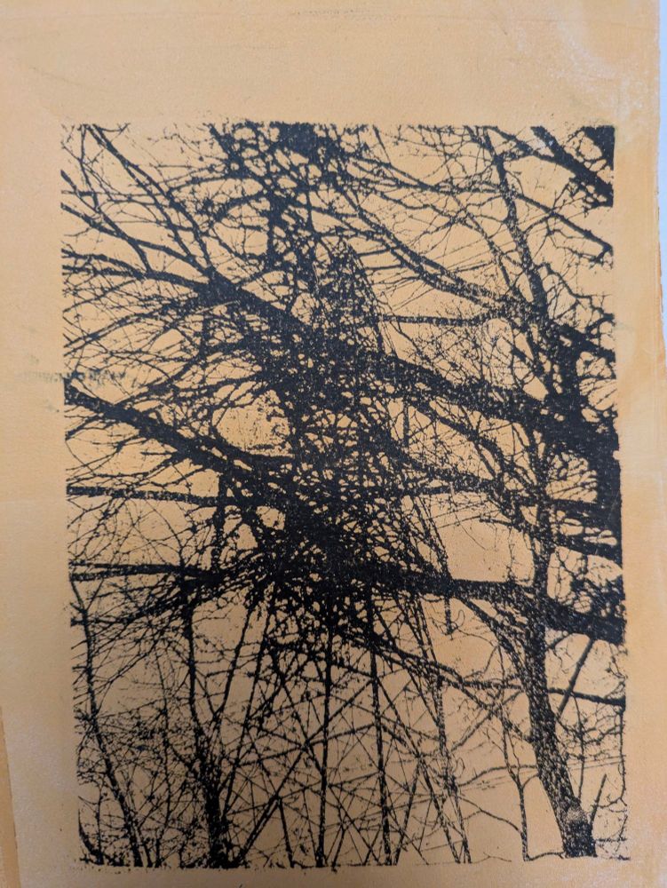 Print of tree branches with electricity pylon tower behind, black print on pale yellow background 