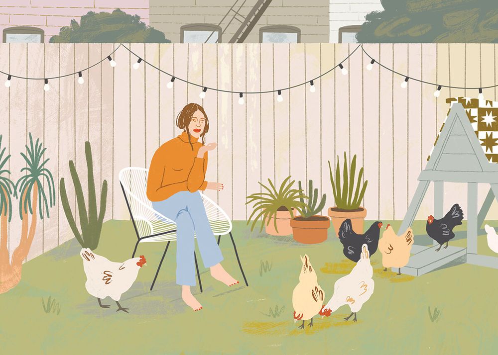 A woman with several backyard chickens.