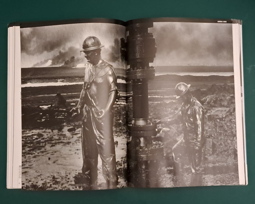 Hundreds of Kuwaiti oil wells were sabotaged by departing Iraqis during the Gulf War in 1991, turning the desert into a poisoned inferno. Specialist firefighters moved in an attempt to minimise the damage. In this photo by Sebastião Salgado, a well-capping operation is being completed by American specialists.