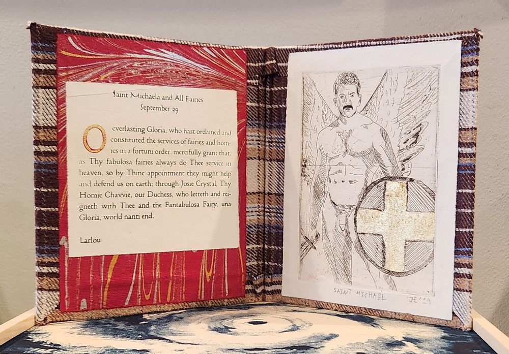A bifold: on one side a prayer for Saint michael in Polari, on the other an etching of a nude saint michael embellished with gold leaf.