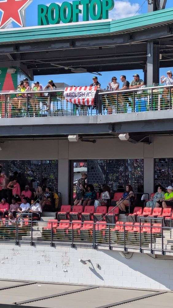 White and red flag that says Abolish ICE