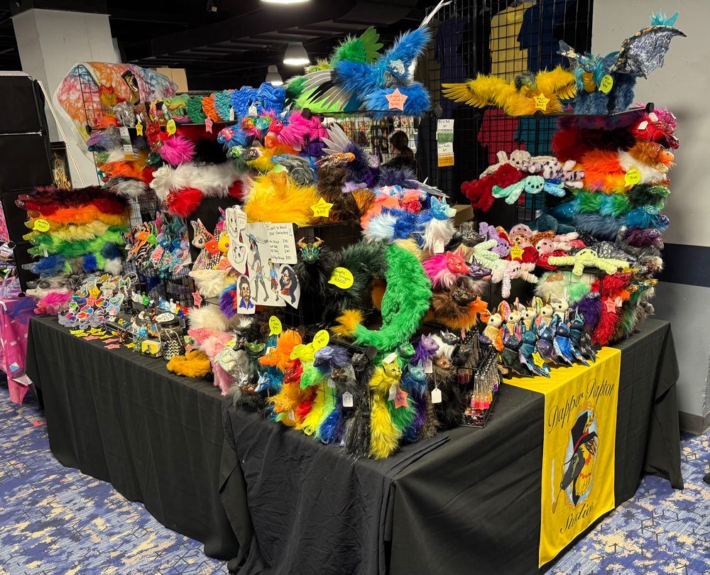 Picture of various wares including plush bats, art dolls of mythical creatures, and dragons