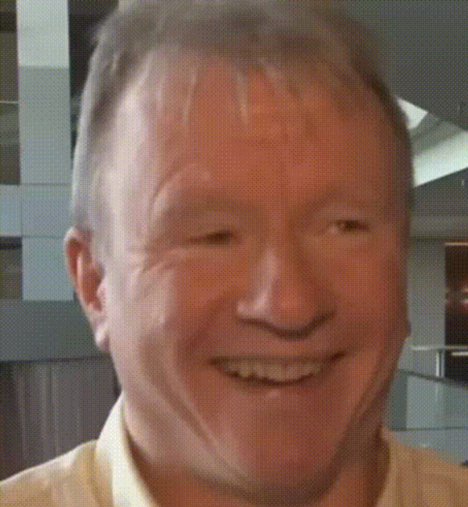 a close up of a man 's face with a smile on his face