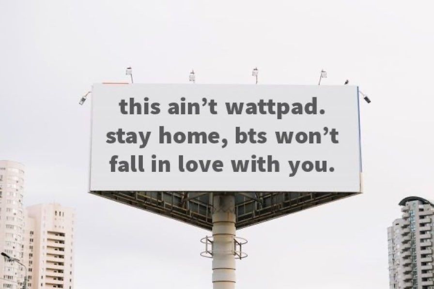 A billboard in a city that says "this ain't wattpad. Stay home, bts won't fall in love with you."