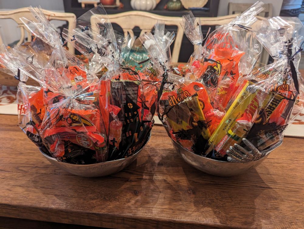 Bagged up candy sitting in two bowls.