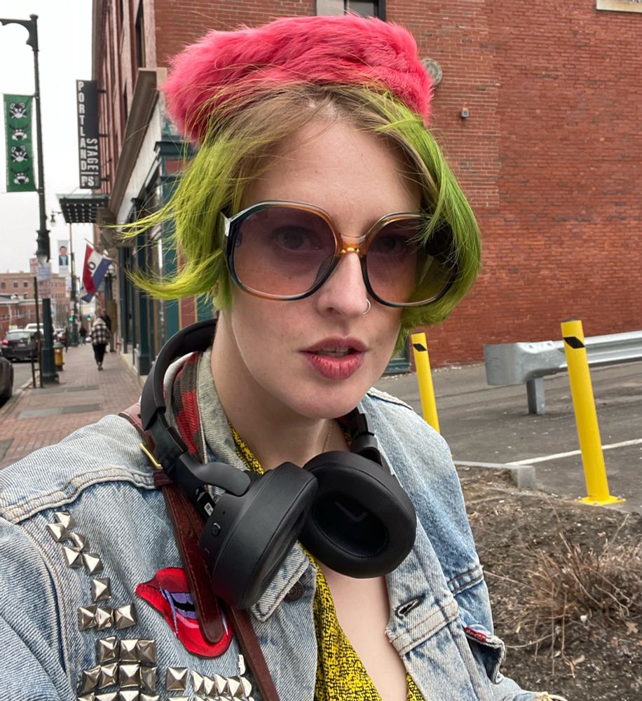 Me with green hair, sunglasses, and pink fur pillbox hat