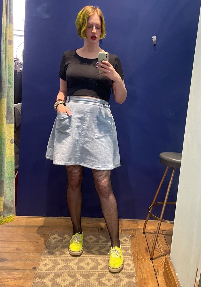 Full length mirror selfie of me in black shirt, light blue wrap skirt, black fishnets, and neon yellow shoes