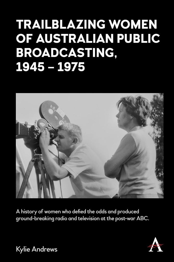 cover of the book Trailblazing Women of Australian Public Broadcasting 1945-1975 by Kylie Andrews. The book is black, with white text. The cover image is B&W whopping a woman with her arms folded, standing beside a man filming with a reel film camera marked ABC. It looks sunny. 