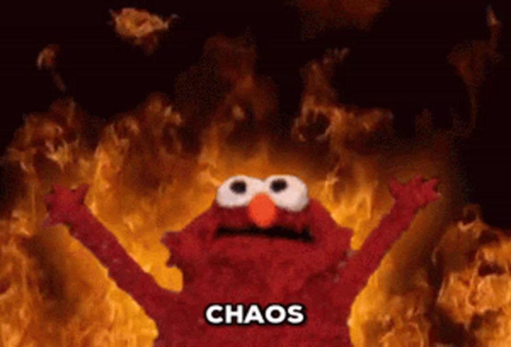 elmo from sesame street is surrounded by flames and the word chaos is above him