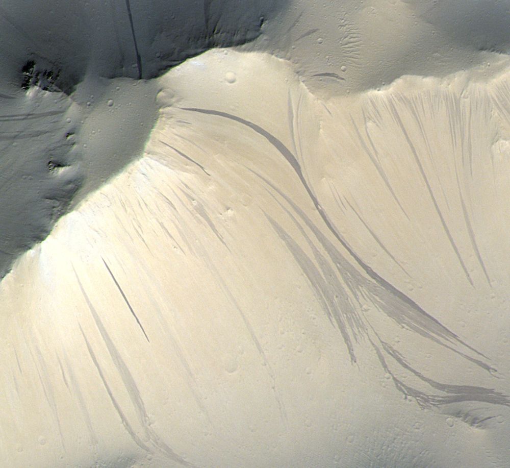 Bright and dark streaks covering the slopes of the Olympus Mons aureole, as seen by the Colour and Stereo Surface Imaging System (CaSSIS) on board ESA's ExoMars Trace Gas Orbiter.