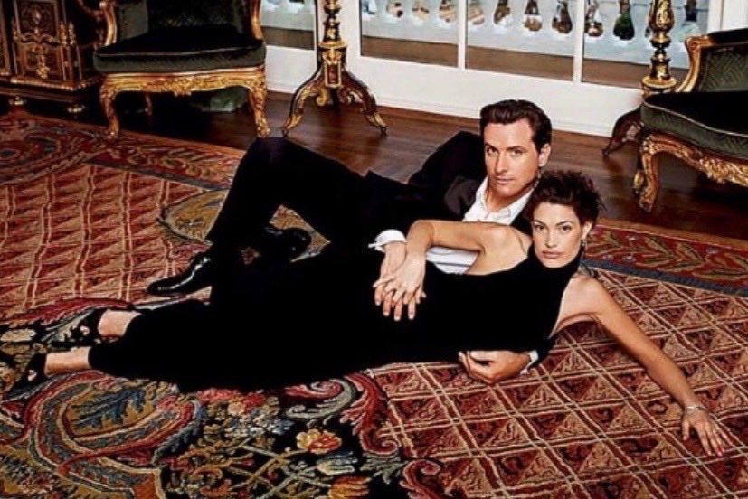 Photograph of Kimberly Guilfoyle and Gavin Newsom in formalwear sprawled out on an ornate rug in a Getty mansion in 2004 a.k.a. the greatest photo of all time.