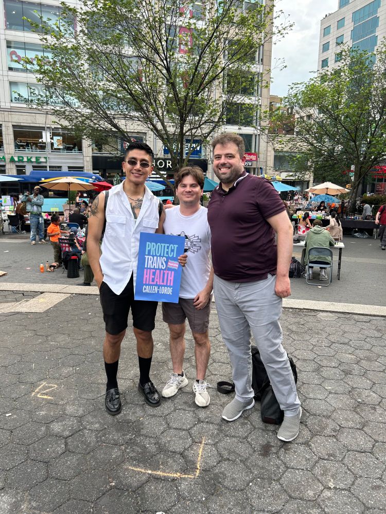 LID standing up for trans rights in Union Square. Three LID members (Patrick, Derek, and Frank) with "Protect Trans Health" sign from Callen-Lorde.