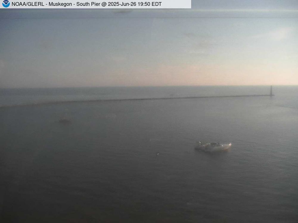Wide view of the Muskegon channel southern breakwater stretching into Lake Michigan. // Image captured at: 2025-06-26 23:50:01 UTC (about 16 min. prior to this post) // Current Temp in Muskegon: 77.01 F | 25.01 C // Precip: broken clouds // Wind: W at 1.946 mph | 3.13 kph // Humidity: 52%