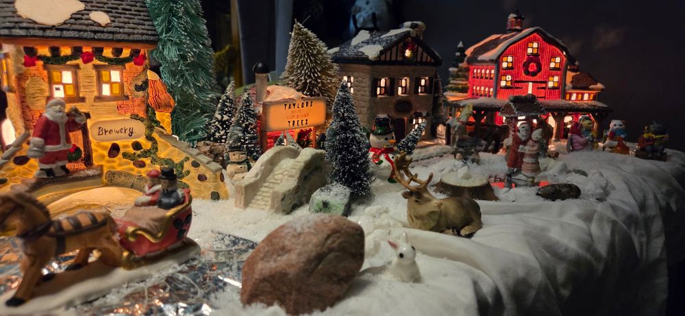 A phone camera picture of a miniature snow/Christmas village.