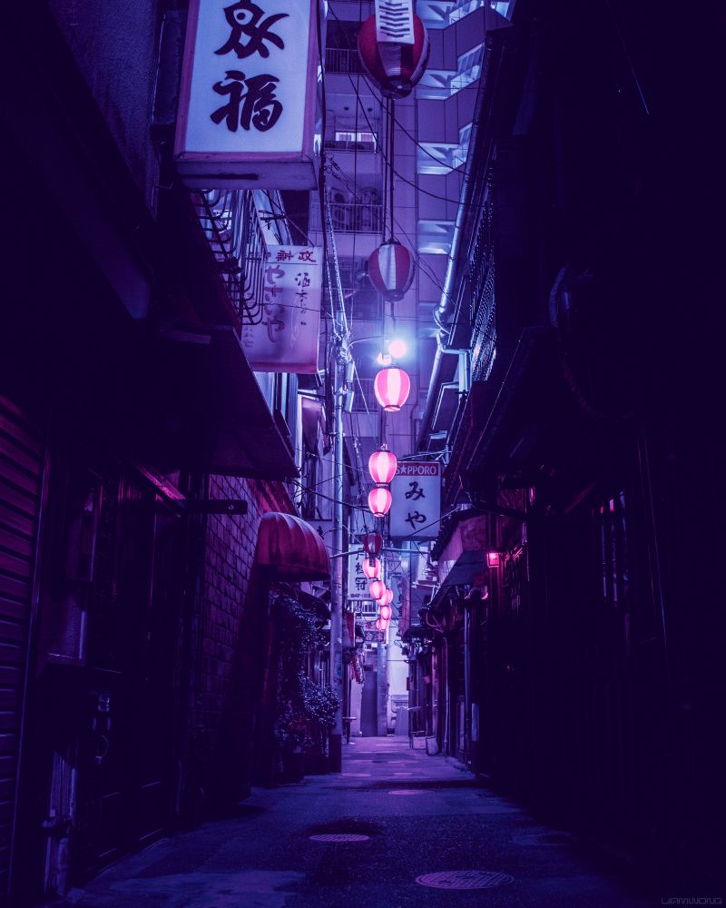 Narrow, lantern-lit, empty alleyway in Shibuya, Tokyo, captured after midnight. The image is purple in color. From Liam’s photography book “TO:KY:OO”. 