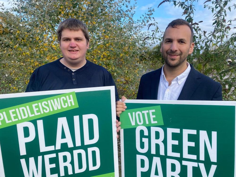 Image of Phil and Zack holding site Green boards


