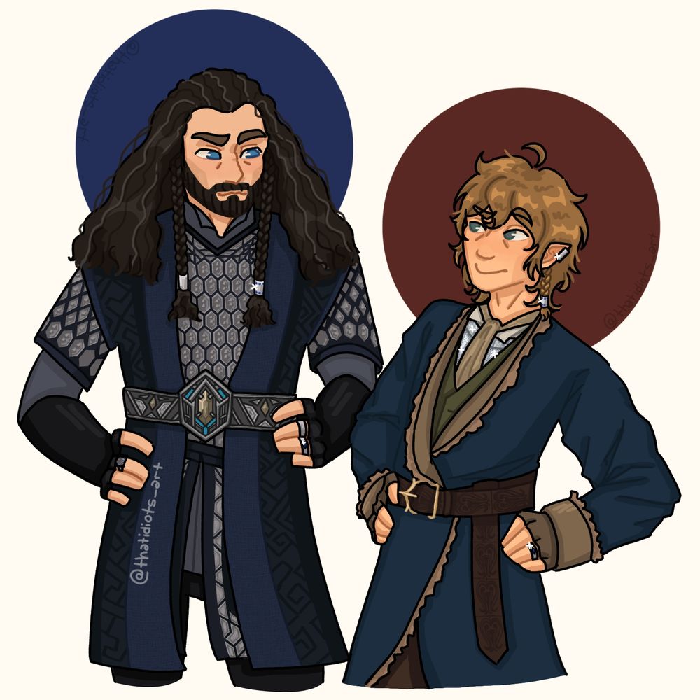 Thorin Oakenshield (left) and Bilbo Baggins (right) are grinning at each other. They're wearing matching hairclips and rings, embedded with blue gems. Bilbo also wears an ear cuff, a gift from the company, and gloves knitted for him by Dori.