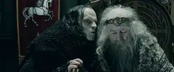 A still from the Peter Jackson film of The Lord of the Rings: The Two Towers. Grima Wormtounge whispers in the ear of a frail Theoden King.