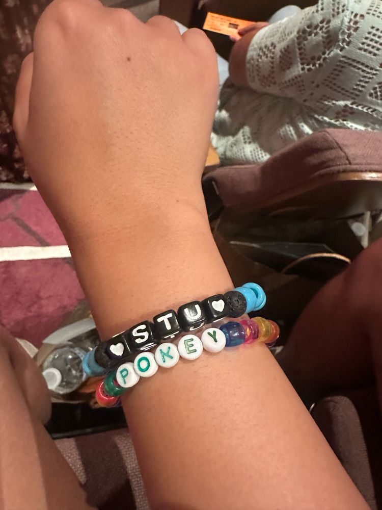 Two friendship bracelets. One says ‘Stu’ and one says ‘Pokey’