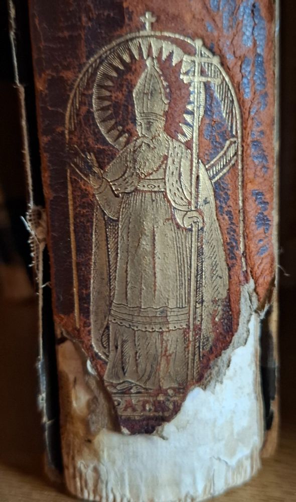 Book spine with St Patrick depicted in gold.