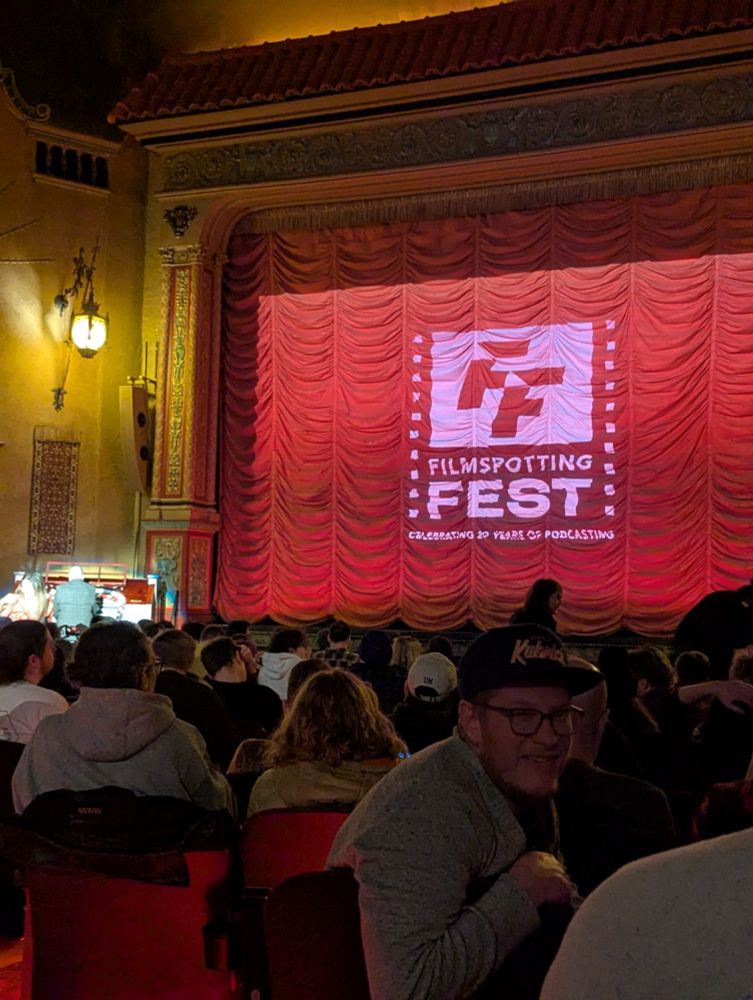 Red drapes and a projection of "Filmspotting Fest"