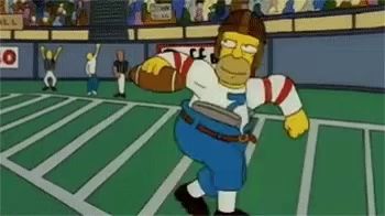 homer simpson is wearing a football helmet and holding a football on a field .