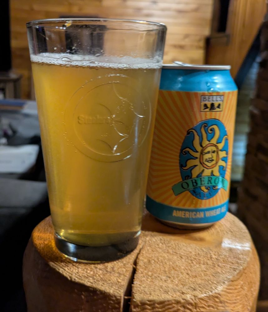 A can of Oberon American Wheat Ale from Bell's Brewery poured into a Steelers glass.