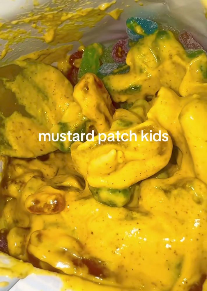sour patch kids covered in mustard. 
says "mustard patch kids"
