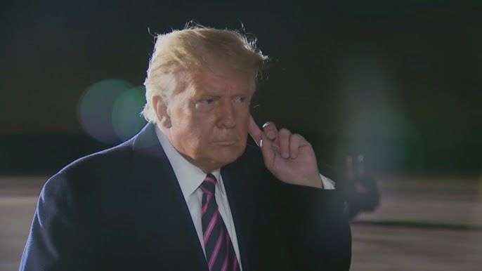 Trump putting a finger up to his ear as if hes hearing something for the first time