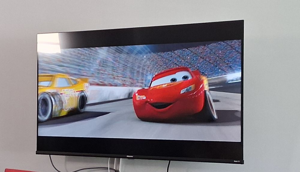 A still of Lightning McQueen racing in Cars (2006)