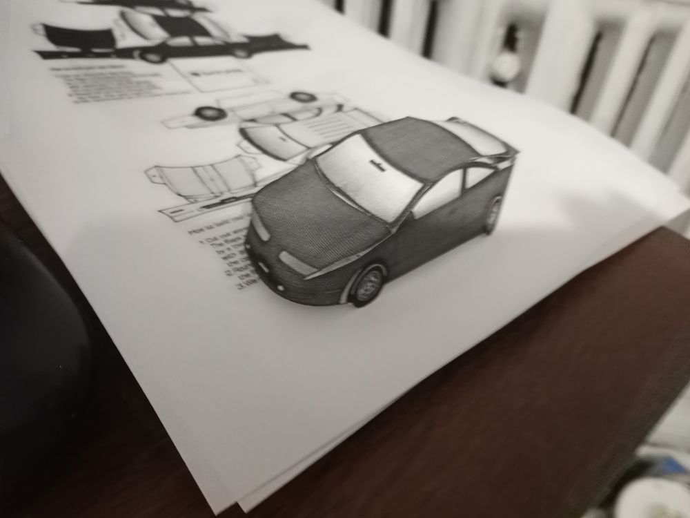 A second generation Saturn SC papercraft - car is in greyscale, and is one of the earlier 2-door models rather than the later 3-door.