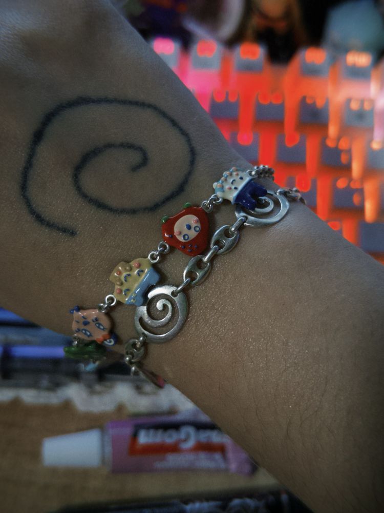 Spiral bracelet and enamel tamagotchi bracelet, both silver 