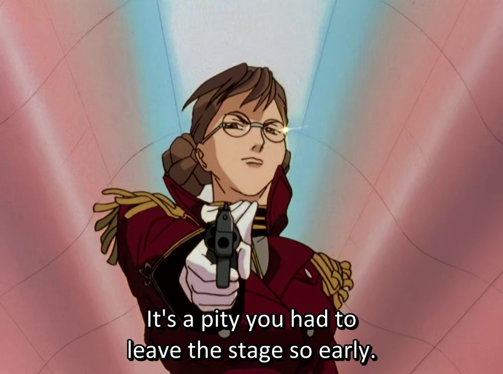 Lady Une shooting at the screen and saying "It's a pity you had to leave the stage so early."  The lighting behind her is colored like the trans flag.